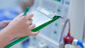 Documenting patients’ vital records, including their blood pressure.